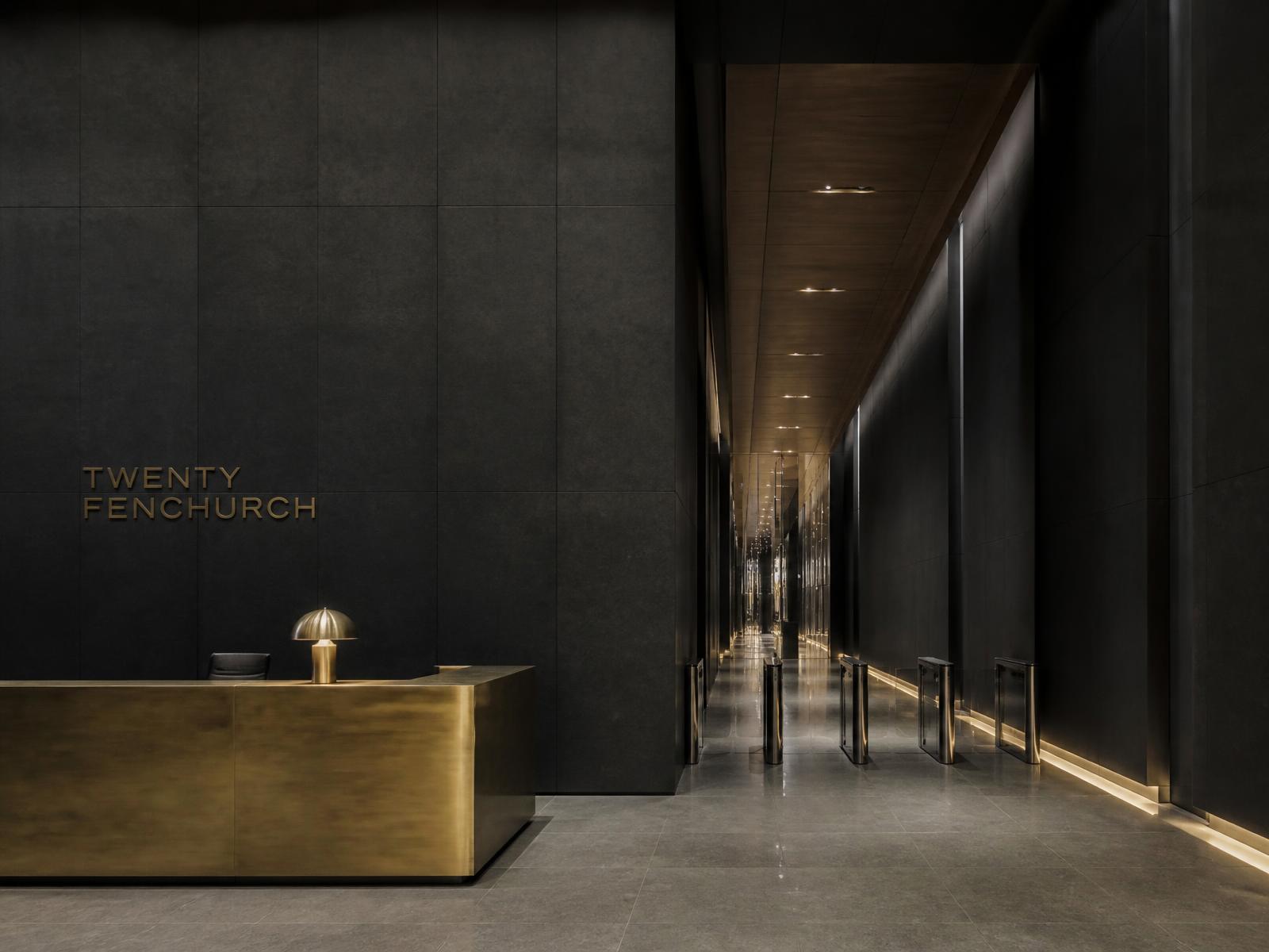 Commercial lobby with stone and brass detailing — project inspiration — illustrative visual example of commercial construction standards, not a completed MARCVEX project